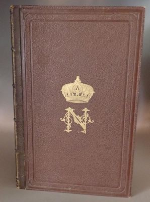 an old book with a crown on top of it sitting on a table