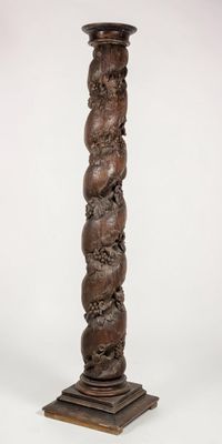 an image of a tall wooden pillar with a carved design on it