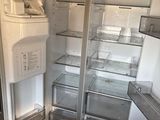 a refrigerator with its door open in a kitchen