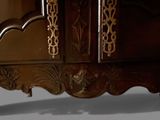 a wooden cabinet with a mirror on top of it