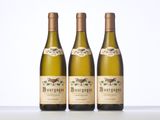 three bottles of wine sitting on top of a table