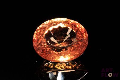 a large orange diamond sitting on top of a black surface