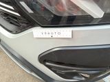 a close up of the front of a car with a sticker on it