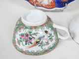 a tea pot with a bird on it next to a plate with a bird on it