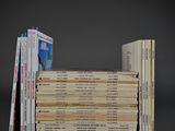 several books stacked on top of each other on a gray surface