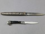 two knives that are laying next to each other on a table