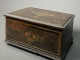 an old wooden box sitting on top of a gray surface