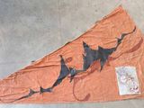 a kite that has a shark on it on the ground