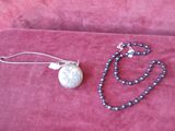 necklace and earring set with silver plated pendant on pink velvet