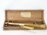 an old brass telescope in a wooden box with a label on it