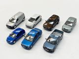 several toy cars are lined up in a row on a white surface