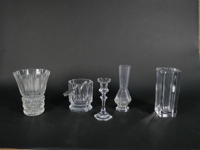 five different glass vases on a black table