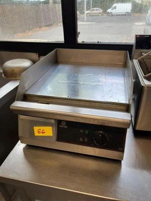 an image of a counter top with a fryer and a pan on it