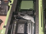 a green case with a camera and other electronics in it