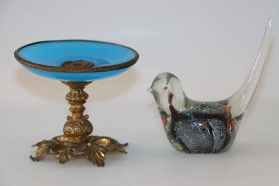 un oiseau et un bol posés l'un à côté de l'autre sur une table