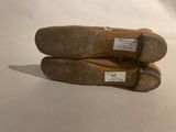 two pairs of shoes are sitting on top of each other