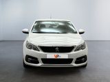 the front of a white car is parked in a large room