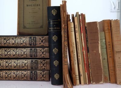 several old books are stacked on top of each other on a table