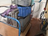 a cart full of boxes and other items in a garage