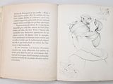 an open book with a drawing of a woman with a flower in her hair