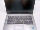 a silver laptop computer sitting on a white surface