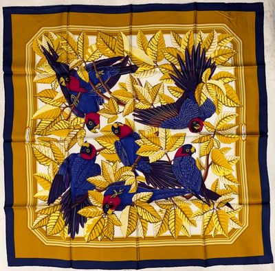 a blue and yellow scarf with birds on it