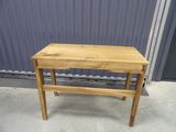 a small wooden table with a drawer on it