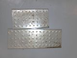two pieces of metal with rivets on them