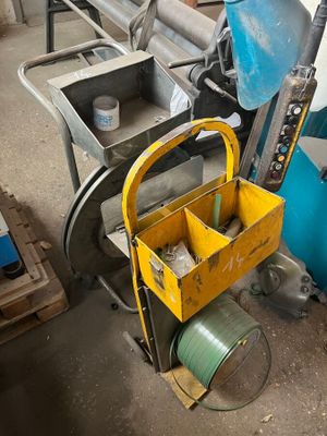 a yellow tool box sitting on top of a cart