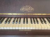a piano that is sitting in the corner of a room