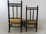two wooden chairs with a patterned seat and back rest