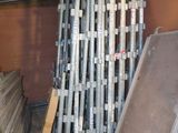 a pile of metal pipes stacked up in a room