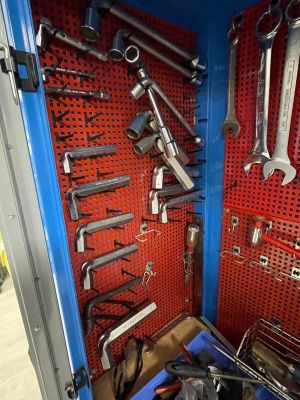 a blue tool box filled with wrenches and other tools
