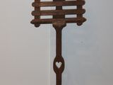 a wooden sign on a stand with a heart on it