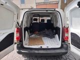 a white van with a mattress in the back of it