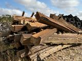 a pile of wood sitting on the side of the road