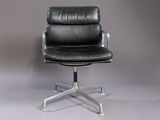 an image of a black leather office chair against a gray wall