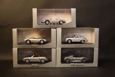 three boxes of silver model cars sitting on top of each other