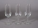 three empty wine glasses sitting on a table
