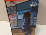 an image of a blue microphone sitting on top of a table