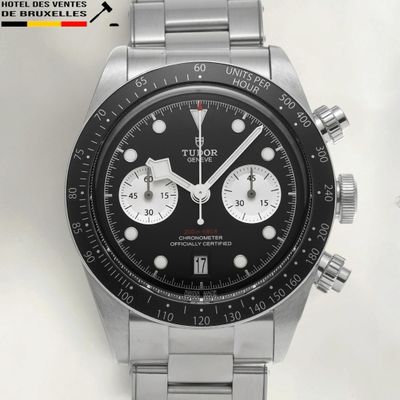 the watch has a black dial on the face of the watch