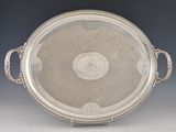 an antique silver plate with handles and handles on a stand