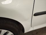 a close up of a white car with a black door handle