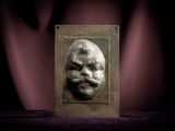 a metal plaque with a picture of a man ' s face on it