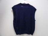 a blue shirt hanging on a wall with a white hanger