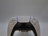 a video game controller sitting on top of a stand