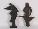 two figurines of a man and a woman on a table