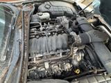 a dirty engine of a car that is parked on the street