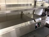 stainless steel counter top in a commercial kitchen with stainless steel appliances