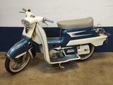 a blue and white motor scooter parked in a garage